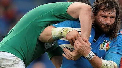 Italy's prop Martin Castrogiovanni (L) is tackled by Ireland's lock Devin Toner during the Six Nations International Rugby Union match between Italy and Ireland at the Olympic Stadium in Rome on February 7, 2015. AFP PHOTO / FILIPPO MONTEFORTE