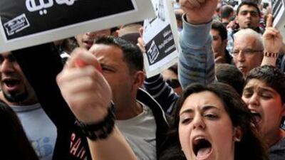 Lebanese protesters hold a placard reading in Arabic 'a secular democracy' during a demonstration calling for the end of the 'confessional' political system in Beirut.