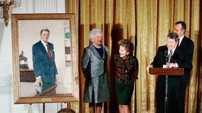 The late former president Ronald Reagan, and former first lady, the late Nancy Reagan, look at a portrait of Mr Reagan along with then president George H W Bush and first lady Barbara Bush, during an unveiling ceremony at the White House in 1989. AP