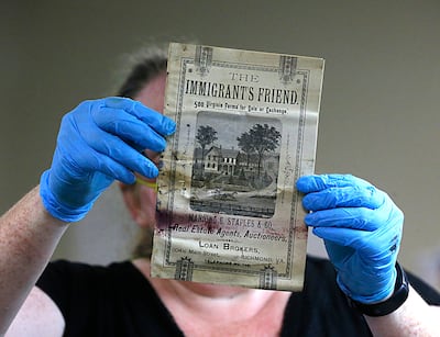 Kate Ridgeway holds a pamphlet titled 'The Immigrant's Friend', one of the artefacts inside a copper box time capsule recovered from the base of a Robert E Lee monument in Richmond, Virginia. Photo via AP,