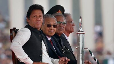 From left, Pakistani Prime Minister Imran Khan, his Malaysian counterpart Mahathir Mohamad and Pakistani President Arif Alvi attend Pakistan's Republic Day parade in Islamabad on March 23, 2019. AP Photo