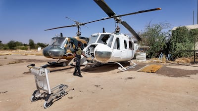 A member of the Sudanese army looks at destroyed helicopters at Khartoum Airport after the Sudanese army deepened its control over the capital from the Rapid Support Forces. Reuters