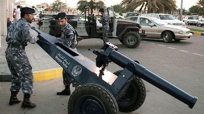 Members of Sarjah police prepare a cannon in one of the streets 12 January, to be fired at sunset to inform Moslems that it is time to break their fast after a long day of not eating, drinking and smoking.