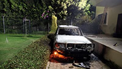A burnt-out vehicle sits smouldering in flames after it was set on fire inside the US consulate compound in Benghazi late on September 11, 2012. AFP