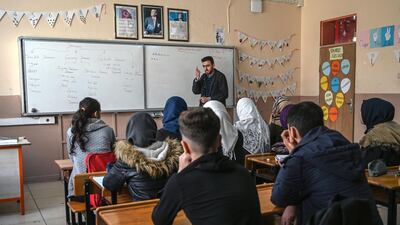 A Syrian teacher gives maths class to Syrian children in a classroom at Sehit Duran primary school in Adana. AFP