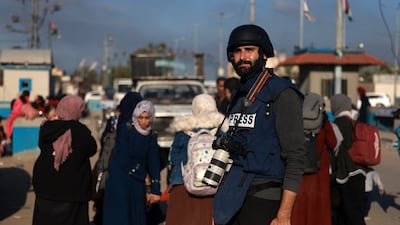 Palestinian photojournalist Motaz Azaiza, who has been documenting the impact of the war between Israel and the Hamas group in the Gaza Strip, stands in a street in the central part of the Palestinian territory on December 18, 2023. (Photo by Mohammed ABED / AFP)