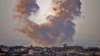 Smoke rises above opposition held areas of the Daraa province countryside during airstrikes by Syrian regime forces on June 27, 2018. Mohamad Abazeed/AFP