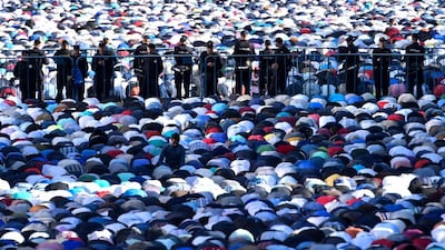 Police stand among Russian Muslims praying outside the central mosque in Moscow. AFP
