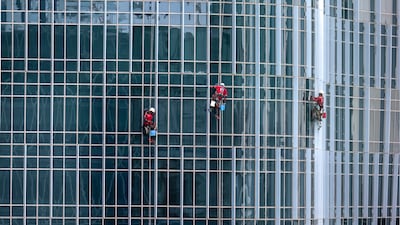 Window cleaners at work on Al Maryah Island in Abu Dhabi. Victor Besa / The National