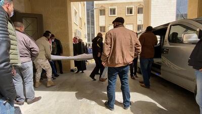 Families of the victims wait outside the morgue to collect the bodies of their loved ones.