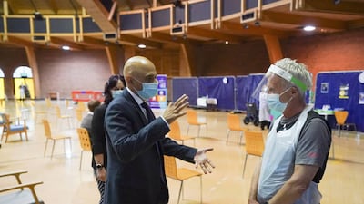 UK Health Secretary Sajid Javid talks to a staff member at the Bournemouth Vaccination Centre in Dorset, on August 4. Getty