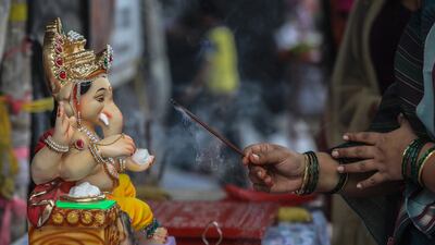Indian devotee offers prayer to an idol of the elephant-headed Hindu God Ganesha, before taking it to their home on the occasion of Ganesh Chaturthi, in Mumbai, India, 31 August 2022. The Ganesh Chaturthi festival is a ten-day long event which is celebrated all over India. During the Ganpati festival, that is celebrated as the birthday of Lord Ganesha, idols of the Hindu deity are worshipped at hundreds of pandals or makeshift tents before they are immersed into water bodies. EPA / DIVYAKANT SOLANKI