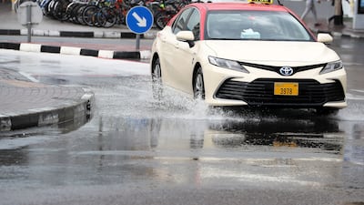 A taxi negotiates flooded roads in Al Karama, Dubai. Pawan Singh / The National