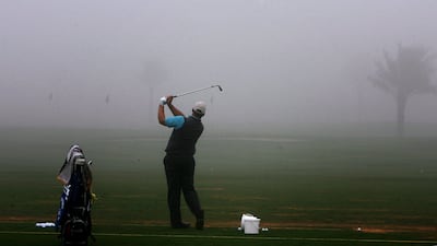 A golfer practices amid heavy fog at the Dubai Golf Club at the start of the 20th Dubai Desert Classic on January 29, 2009. The tournament got off to a fog-delayed start with world number two Sergio Garcia and three-time former winner Ernie Els among the favourites. AFP PHOTO/MARWAN NAAMANI *** Local Caption *** 984751-01-08.jpg