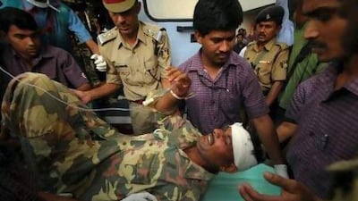 Paramedics rush an injured policeman to hospital in Nagpur on Tuesday. A roadside bomb triggered by suspected Maoist guerrillas killed 11 policemen and injured 29 in a remote part of the western Indian state of Maharashtra, police said.