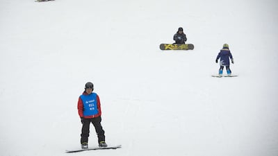 Visitors snowboard at the Dalian Wanda Ice and Snow Park in Harbin, the world's largest indoor ski park, on August 22, 2017. Nicolas Asfouri / AFP