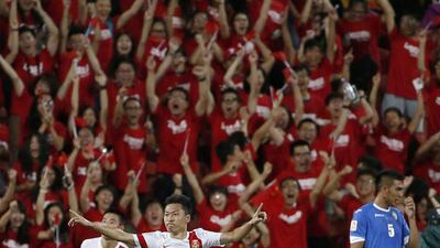 China's Wu Xi celebrates scoring the equaliser against Uzbekistan in his side's 2-1 Asian Cup victory on Wednesday in Brisbane, Australia. Edgar Su / Reuters / January 14, 2015
