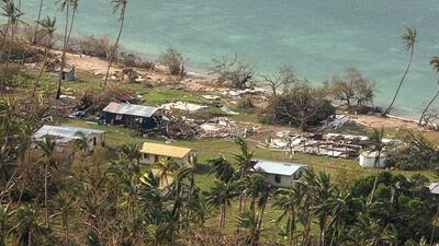 Debris is scattered around damaged buildings at Susui village in Fiji. New Zealand Defense Force via AP