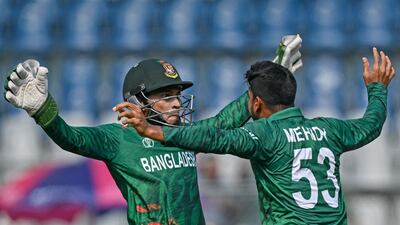 Bangladesh's Mehidy Hasan Miraz celebrates with his teammate Mushfiqur Rahim after taking the wicket of South Africa's Rassie van der Dussen. AFP