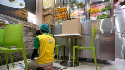 Staff members at House of Tea take turns for Magreb prayers before the beginning of another busy evening.