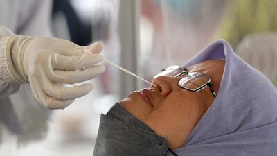 Indonesia steps up its Covid testing as fears of Omicron infection spread. But a leading virologist told 'The National' that it might supplant the Delta variant and cause nothing more than a 'mild cold'. EPA