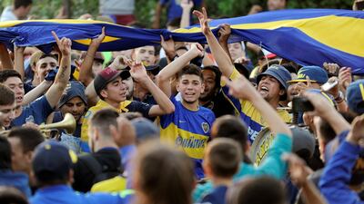 Boca Juniors' fans cheer as their team heads on to Spain. Reuters