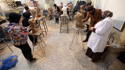 Iraqi students during a sculpture class at the college, a faculty of the University of Baghdad.