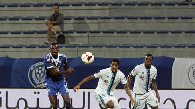 Mohammed Fawzi, centre, Abdul Almukhaini, right, and the rest of their Baniyas spent most of the night chasing Al Nasr's Ibrahima Toure. Jeffrey E Biteng / The National