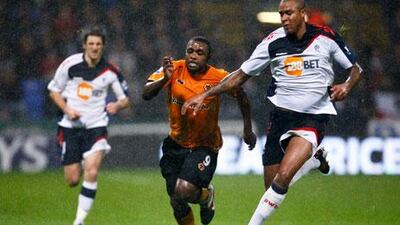 Sylvan Ebanks-Blake, the Wolverhampton player, centre, tries to get ahead of Bolton’s Zat Knight, right.