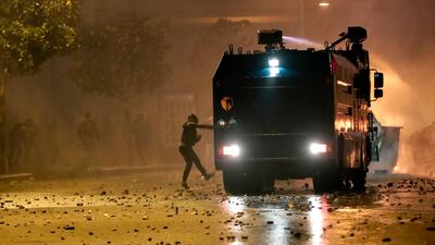 Supporters of Lebanon's Hezbollah and Amal groups clash with security forces late on December 17, 2019 in central Beirut. AFP