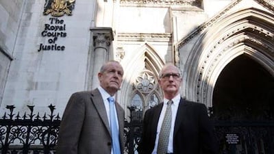 Victim's family members Sean Cassidy, left, and Graham Foulkes as they arrive at the High Courts in London for the start of the Inquests into the bombing of London's transport system.