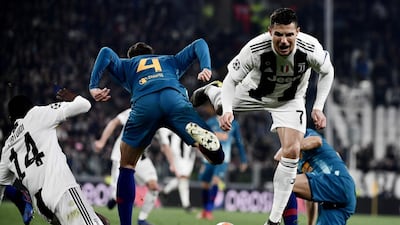 Juventus' Portuguese forward Cristiano Ronaldo, right, collides with Atletico Madrid's Colombian defender Santiago Arias. AFP