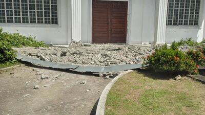 Debris in front of the Marcos photo gallery building in Batac city. AFP