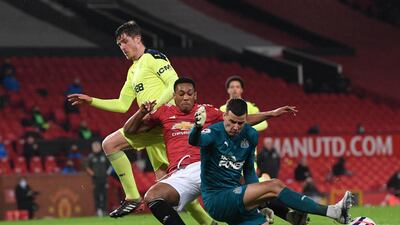 Manchester United's Anthony Martial, centre, challenges for the ball with Newcastle goalkeeper Karl Darlow. AP