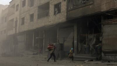 Syrians run from cover in Hamouria during Syrian government shelling on rebel-held areas in the Eastern Ghouta region on the outskirts of the capital Damascus on March 6, 2018. Abdulmonam Eassa / AFP