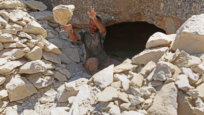A displaced Syrian man digs a cave for shelter near the Syria-Turkey border. AFP