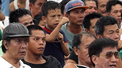 A young Filipino fan of Manny Pacquiao gestures while watching a free live broadcast of his match. Romeo Ranoco / Reuters