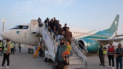 Passengers disembark from a flight operated by Iranian carrier Caspian Airlines at Al Ashraf International Airport in Njaf, Iraq. AFP