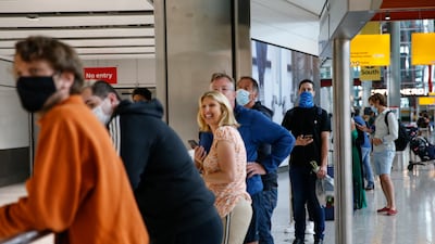 People wait for their loved ones to exit at arrivals in Heathrow Airport. Getty Images