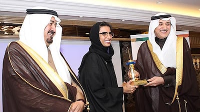 Noura Al Kaabi, chief executive of twofour54, is honoured by Dr Abdulaziz bin Abdullah Al Khudairi, right, Minister of Culture and Information, in Riyadh. Abdul Rahman bin Abdul Aziz Al Hazza, left, is the president of Saudi Broadcasting Corporation. Courtesy twofour54