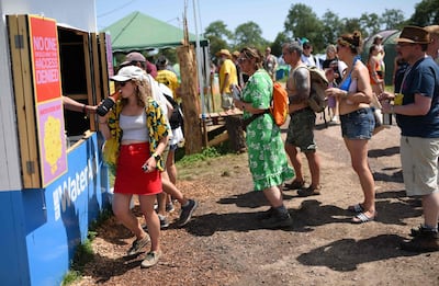 Revellers queue to fill their water bottles at a water re-filling station at the Glastonbury Festival of Music and Performing Arts in Somerset, South West England. AFP