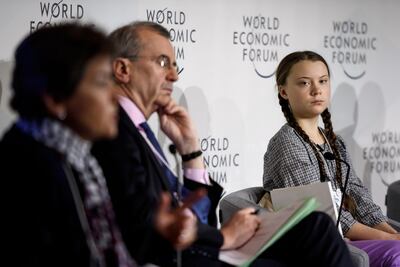 Greta Thunberg on a panel at Davos with moderator Christiana Figueres (left) and governor of the Bank of France, Francois Villeroy de Galhau. Fabrice Coffrini / AFP