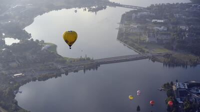 Hot air balloons are seen flying over Lake Burley Griffin at the canberra Balloon Festival in Canberra, Australia. This year marks the 30th anniversary of the Canberra Balloon Festival, considered one of the biggest hot air balloon festivals in the world. Lukas Coch / EPA