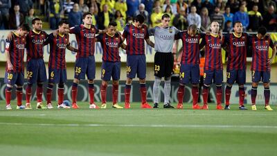 Barcelona players observe a minute of silence in commemoration of former manager Tito Vilanova, who died on April 25 due to a cancer in the parotid gland, before their La Liga match against Villarreal on Sunday. Juan Carlos Cardenas / EPA / April 27, 2014