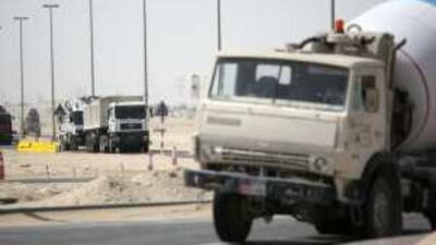 Lorries continue to roll along Road 33 in Khalifa City B yesterday.