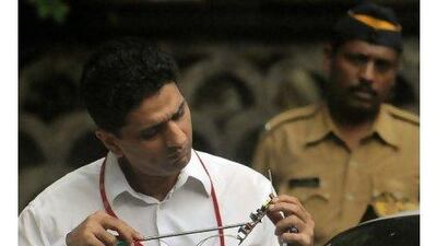 Indian detectives inspect a device found at the blast site in the Dadar West suburb of Mumbai.
