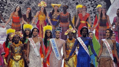 Megan Young, born in the US and moved to the Philippines when she was 10. She is a TV host with Filipino network ABS-CBN. Here she joins hands with runner-up Marine Lorphelin of France, second runner-up Carranzar Naa Okailey Shooter of Ghana and People's Choice Maroua Kharbouch of Gibraltar. Murdani Usman / Reuters