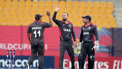 Rohan Mustafa, centre, was named man of the match for his four wickets and team-leading 39 runs against Ireland. Pawan Singh / The National