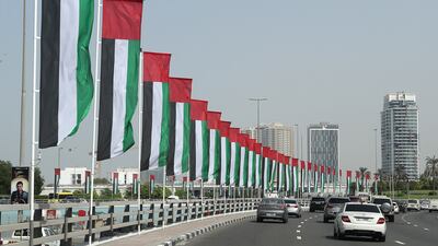 UAE flags lining a street in Dubai. Non-oil business activity has maintained a robust growth momentum this year. Pawan Singh / The National