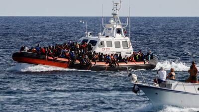 An Italian Coast Guard boat carries migrants rescued at sea near the Sicilian island of Lampedusa, Italy, on September 18. Reuters